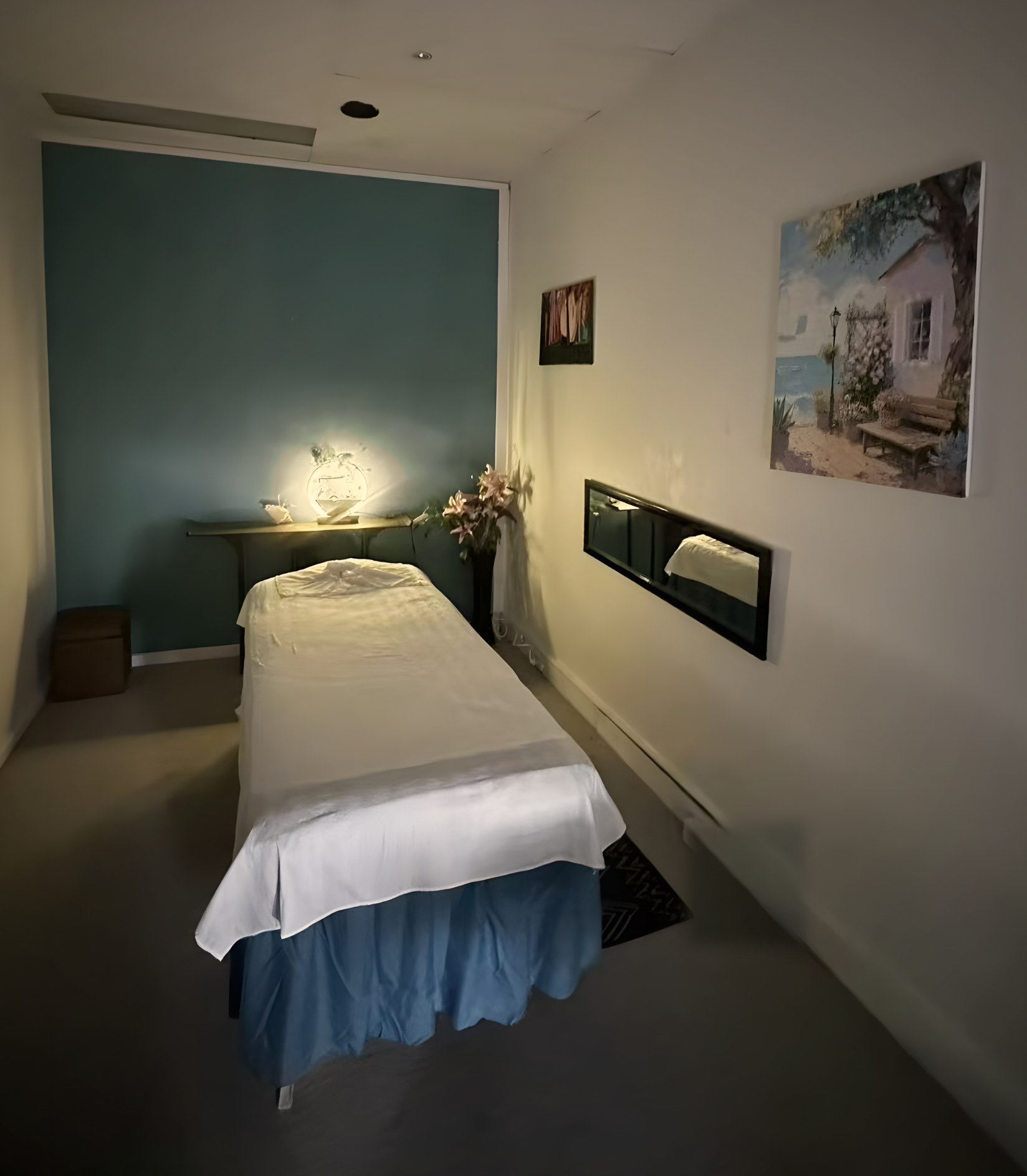 Massage room 1 at Ocean Retreat Massage, Glen Waverley: lamp-lit room with a blue feature wall