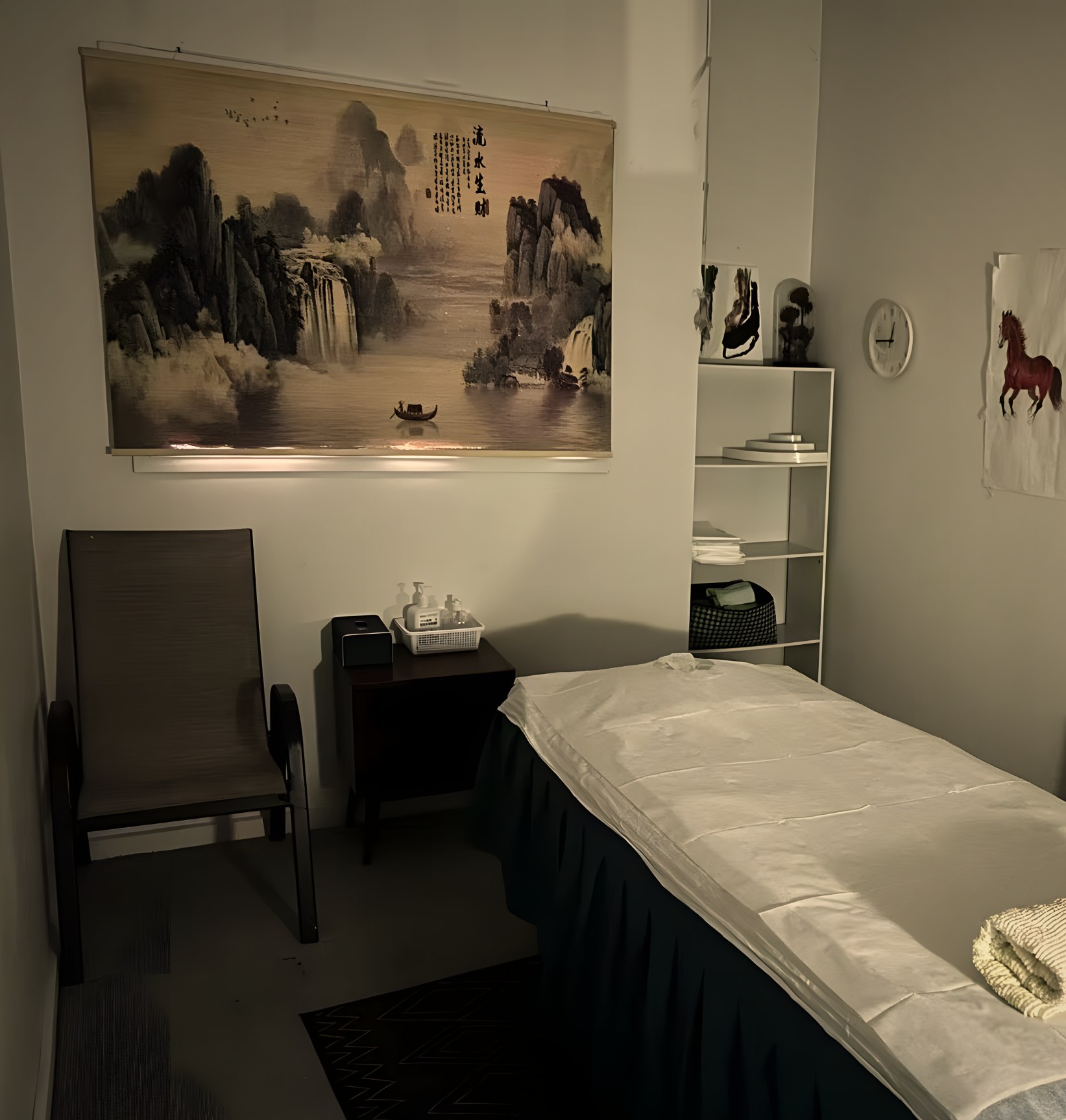 Massage room 3: Chinese landscape scroll, armchair and fresh linen
